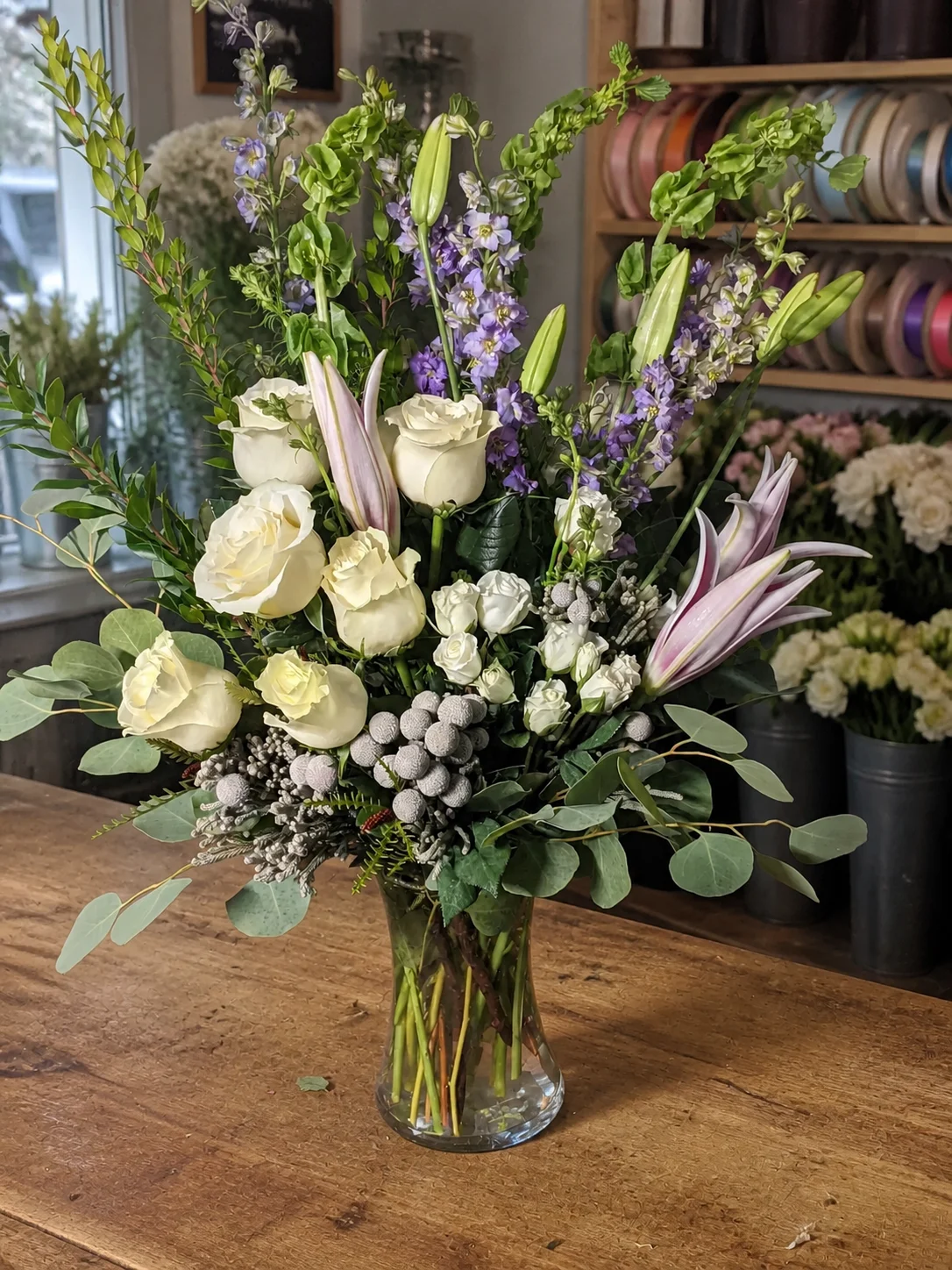 White and lavender sympathy vase arrangement with greenery